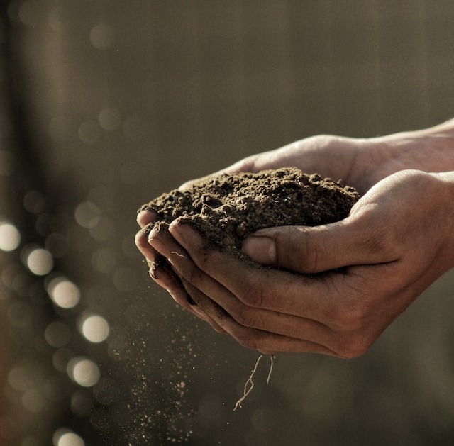 hands capturing dirt - building construction
