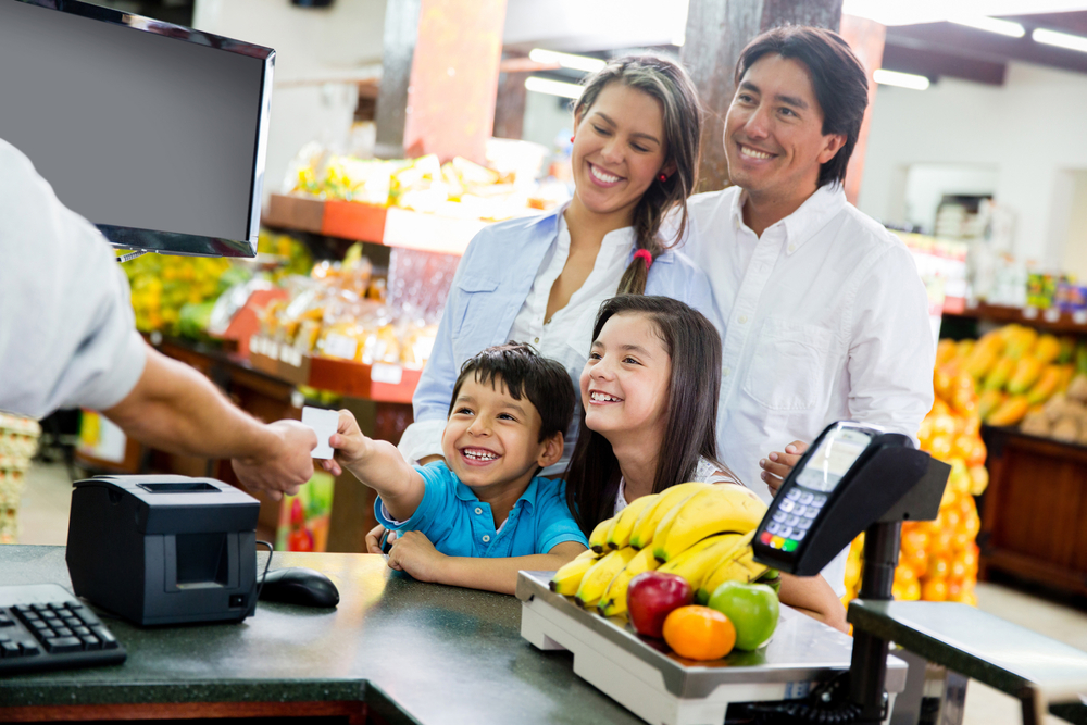 Family looking out for home finances at the supermarket Family looking out for home finances at the supermarket